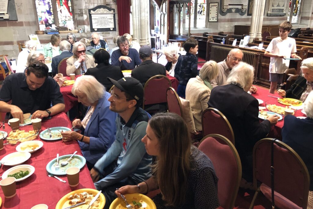 The church family sharing lunch at long tables in church